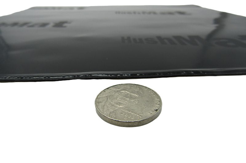 HushMat sheet thickness compared with a coin